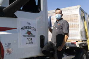 Colleague standing besides a Morning Star truck delivering food products to Newman school district